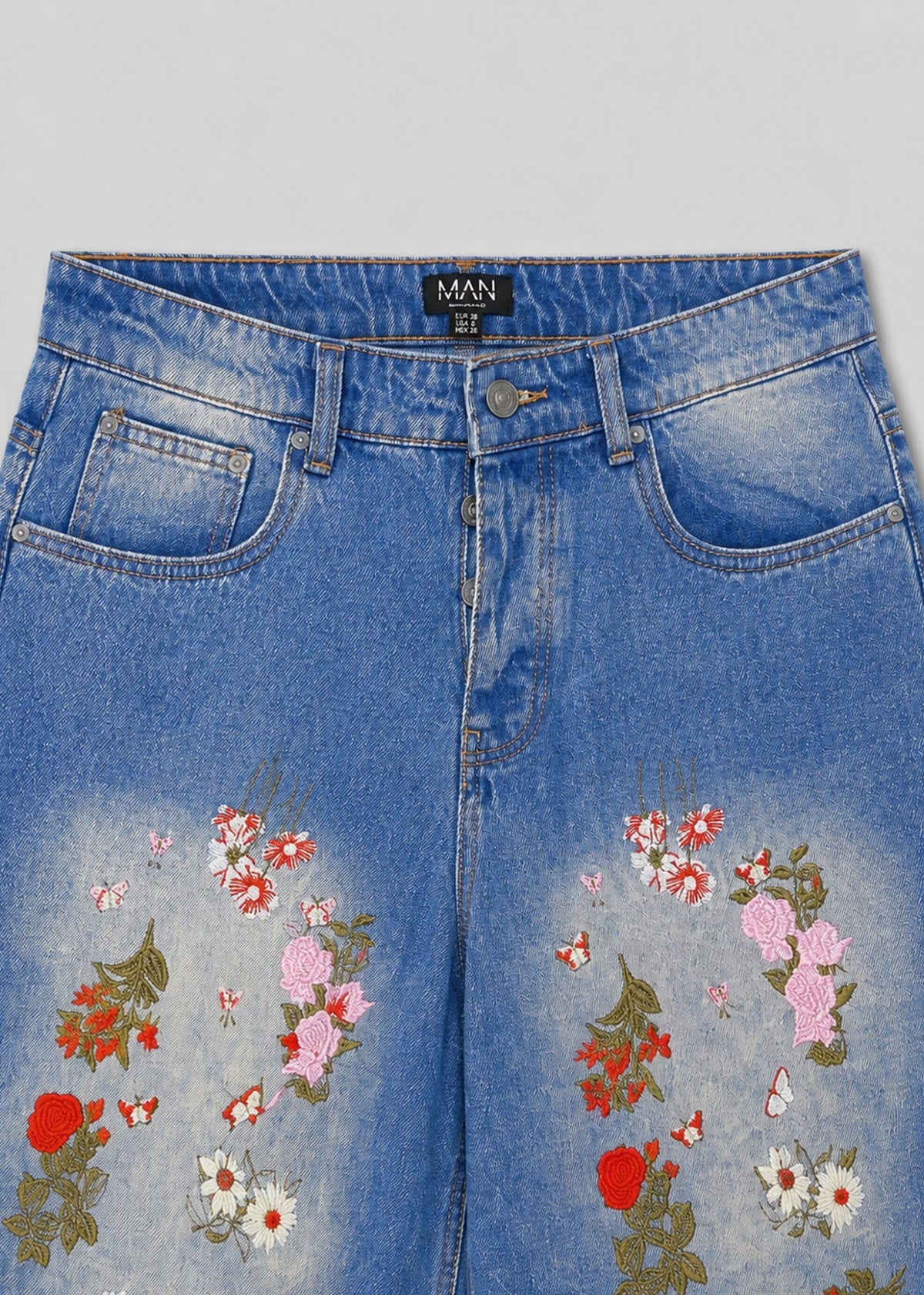 MAN floral embroidered jeans waistband button fly and embroidery detail