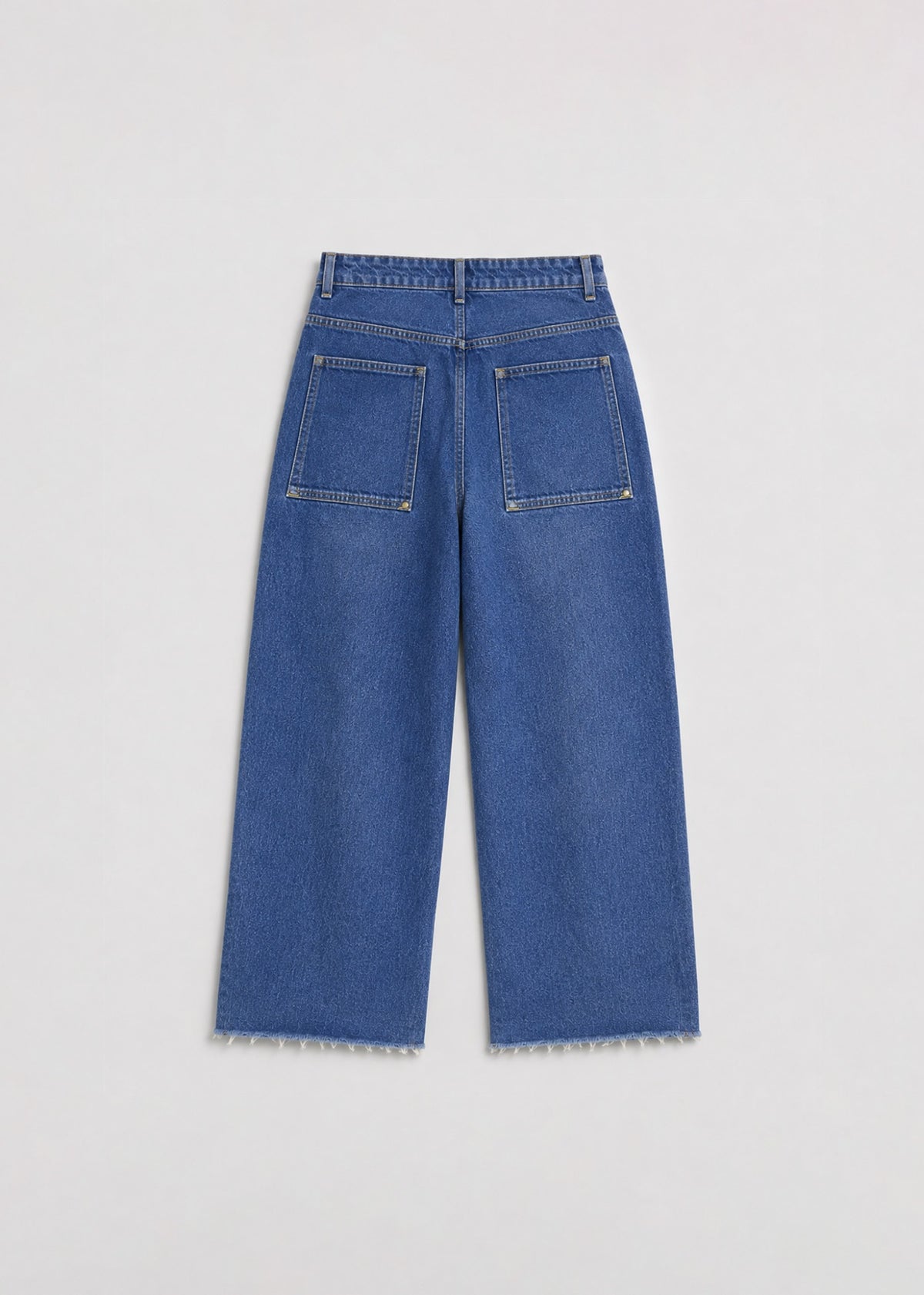 Medium-wash wide-leg jeans back view with oversized riveted pockets