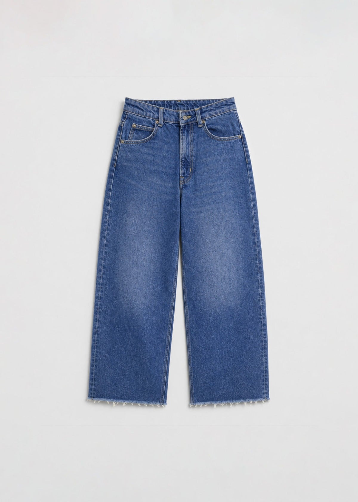 Medium-wash wide-leg jeans front view with raw frayed hem