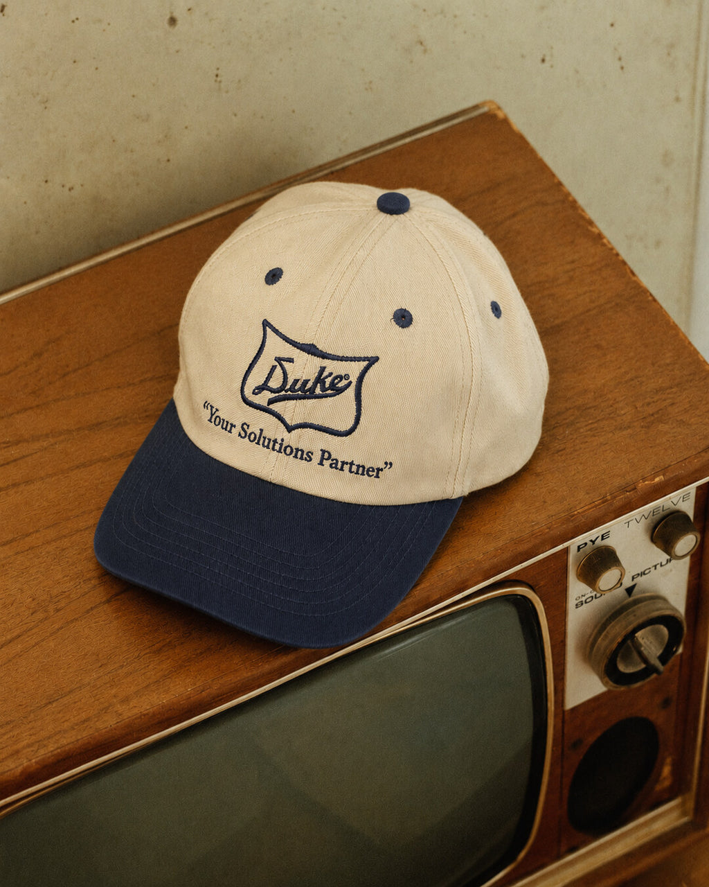 Duke Cream & Navy Embroidered Cap, styled front angle