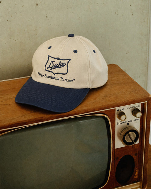 Duke Cream & Navy Embroidered Cap, styled side angle