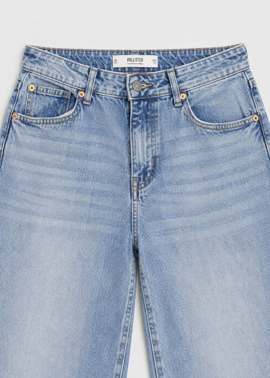 Hollister light wash jeans waistband, brand label and five-pocket detail