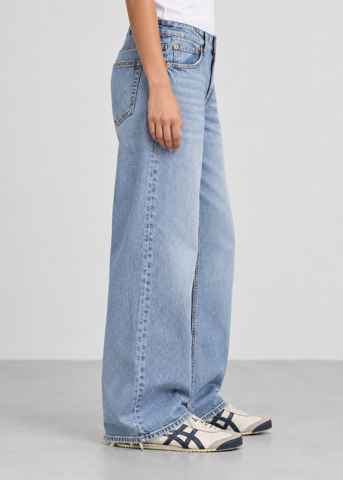 Hollister light wash wide leg jeans on female model, side view
