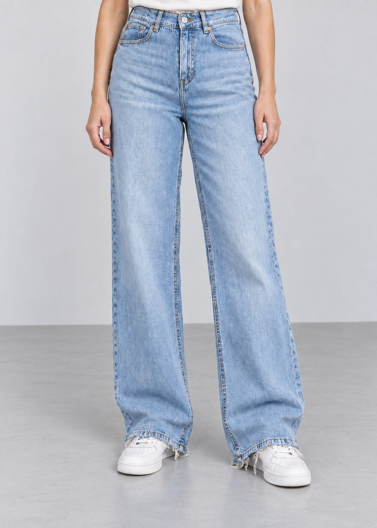 Light wash wide leg raw hem jeans on female model, front view