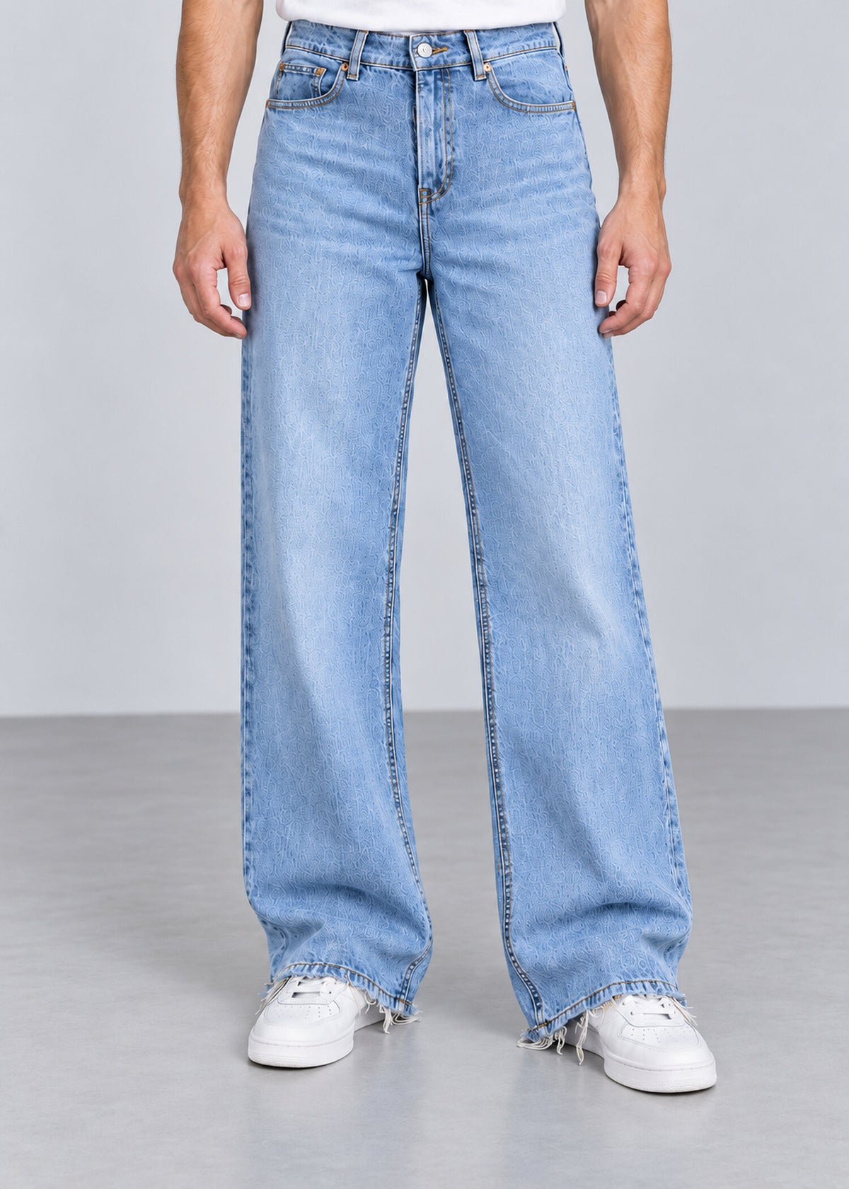 Light wash wide leg raw hem jeans on male model, front view