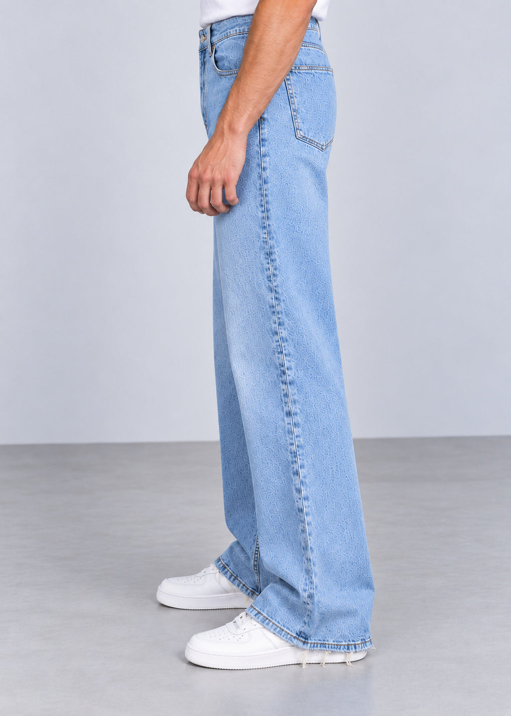 Light wash wide leg raw hem jeans on male model, side view