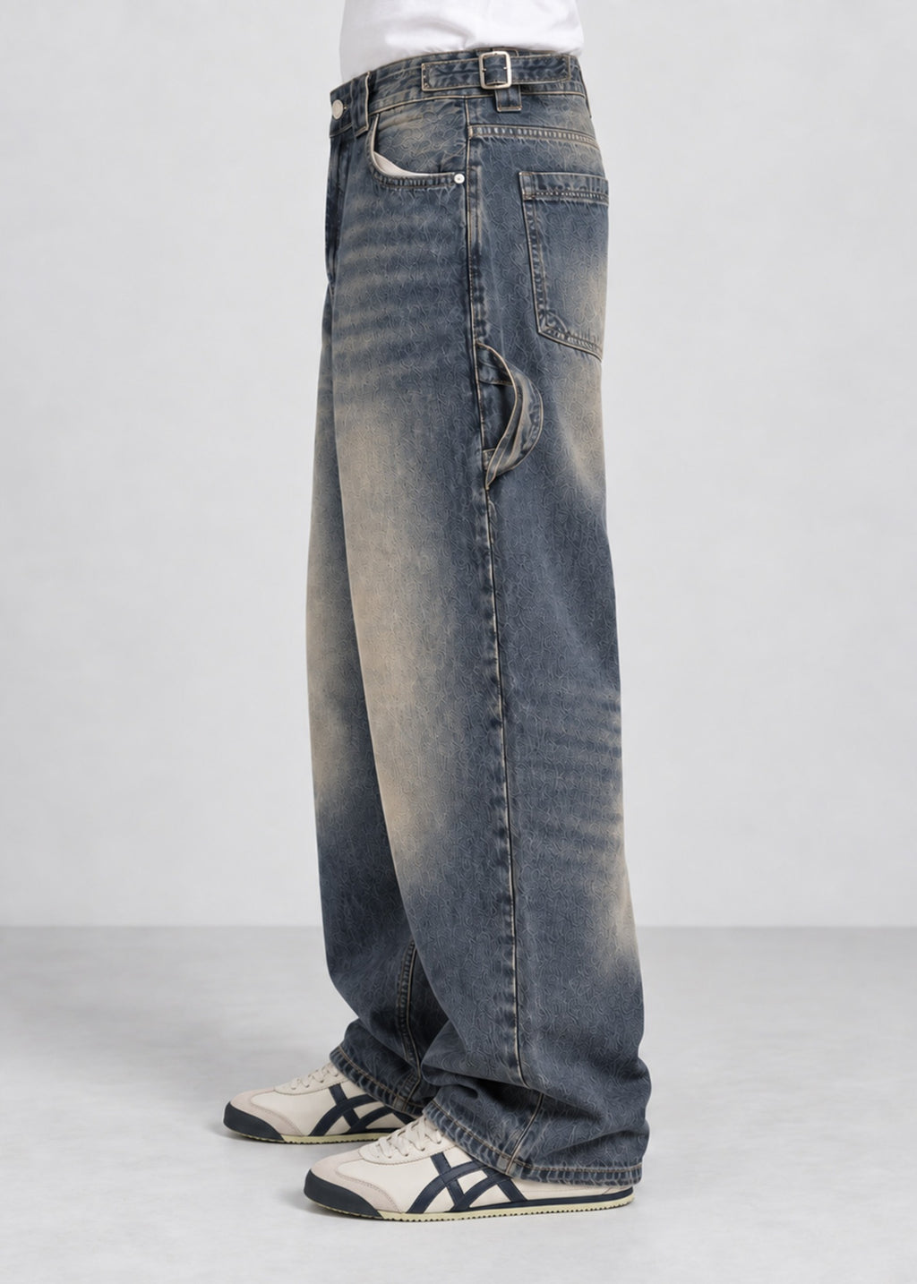 Unisex balloon fit utility jeans worn by male model, side view showing utility strap