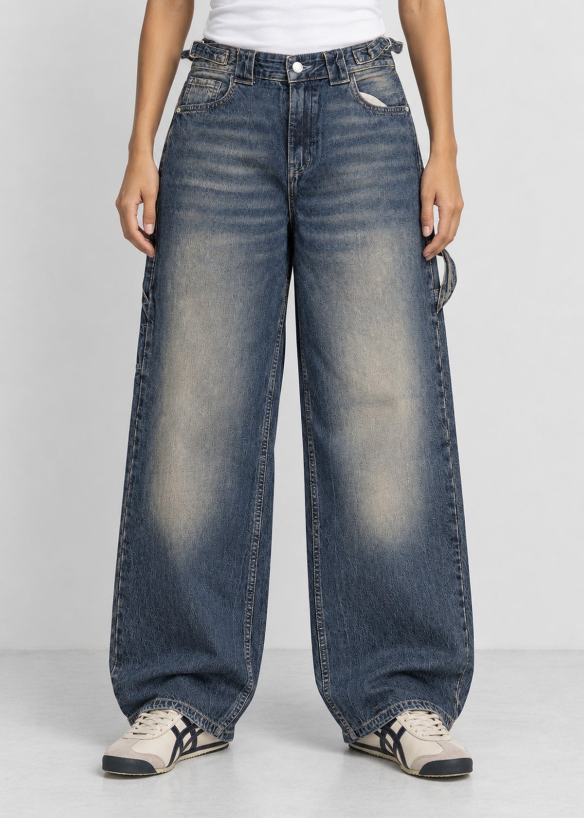 Unisex balloon fit utility jeans worn by female model, front view
