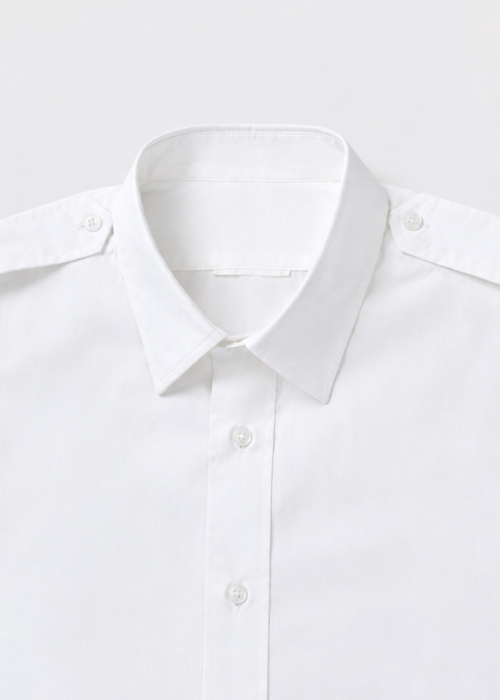 White epaulette shirt collar and shoulder-button close-up
