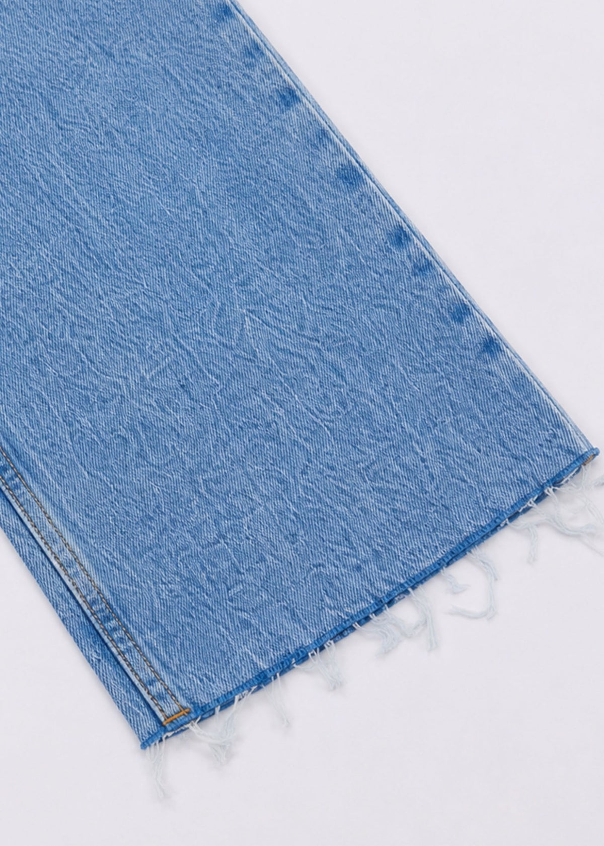 Zara light-wash denim raw frayed hem close-up